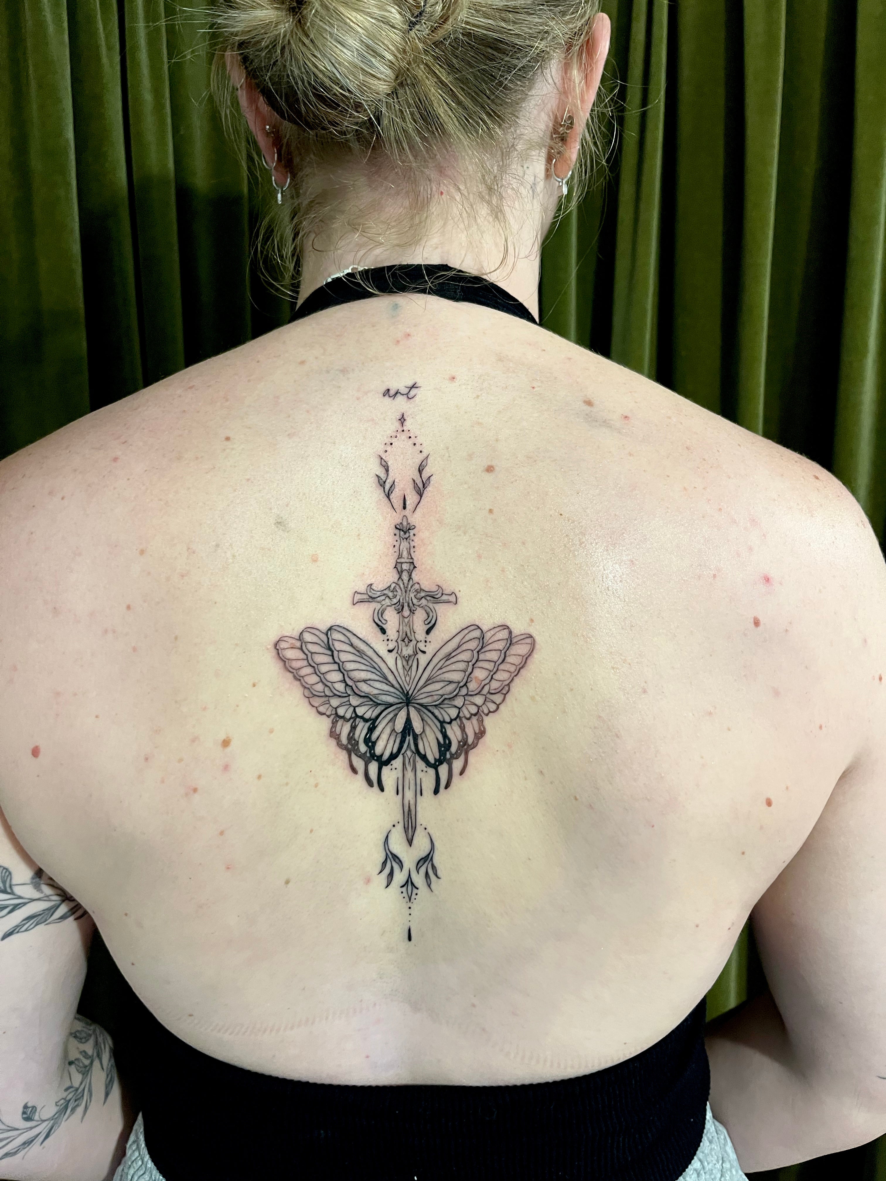 Ornamental spine back fineline tattoo with sword and butterflies tattooed by sugar viper tattoo studio in auckland new zealand