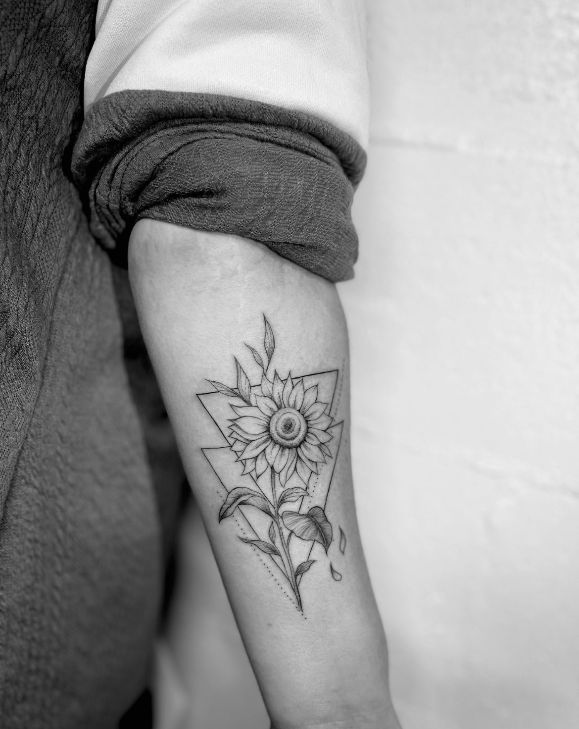 Geometric triangles sunflower floral fineline tattoo on arm tattooed by sugar viper tattoo studio in auckland new zealand